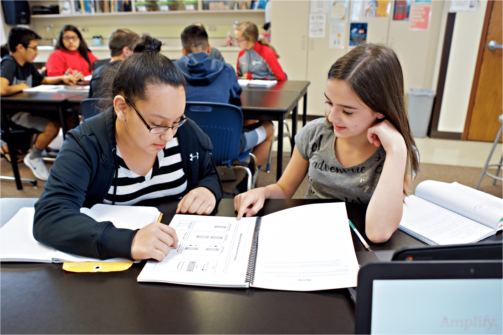 Two middle school girls use a Student Investigation Notebook to take on the role of scientists and engineers