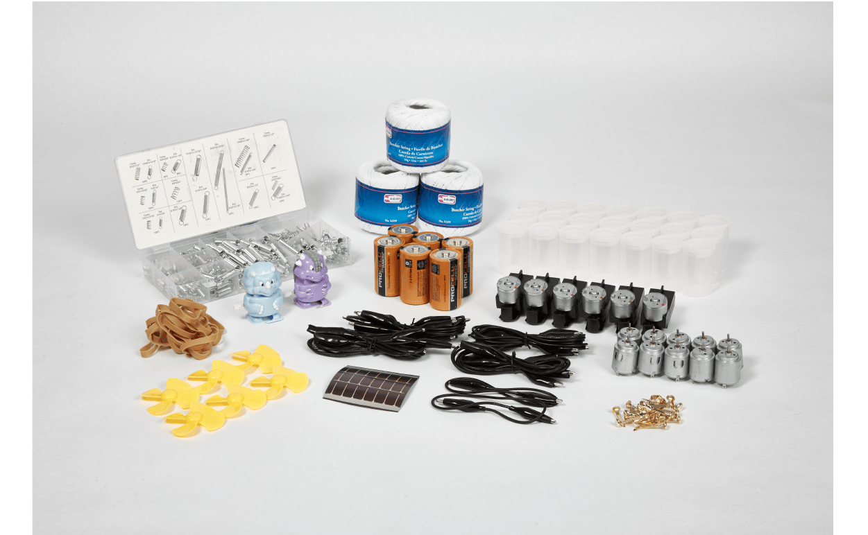 A collection of clear plastic containers, empty dropper bottles, plastic cups, measuring spoons, a bottle of isopropyl alcohol, and colorful gumballs arranged on a white background.