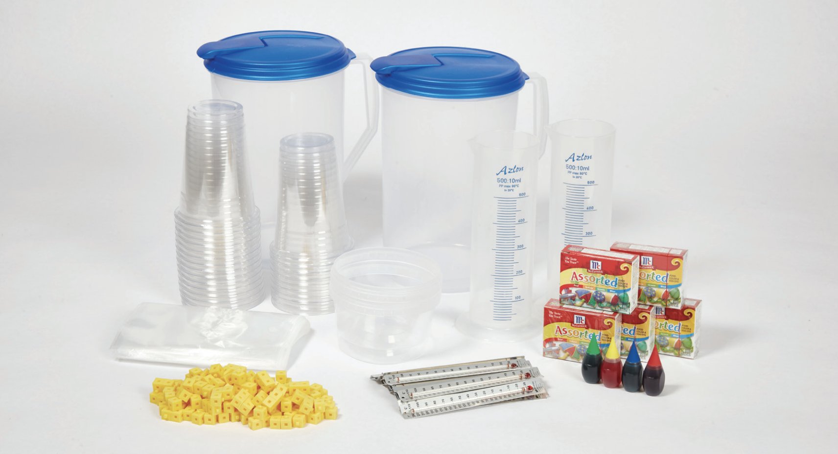 Assorted laboratory supplies including beakers, measuring cylinders, test tubes, pipettes, thermometers, and chemical reagents on a white background.