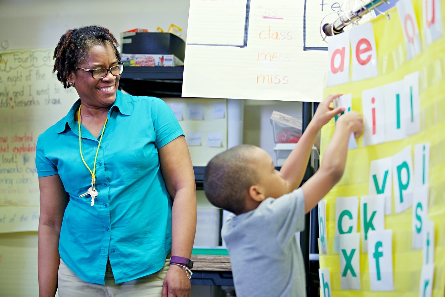 Teacher observes student completing activity