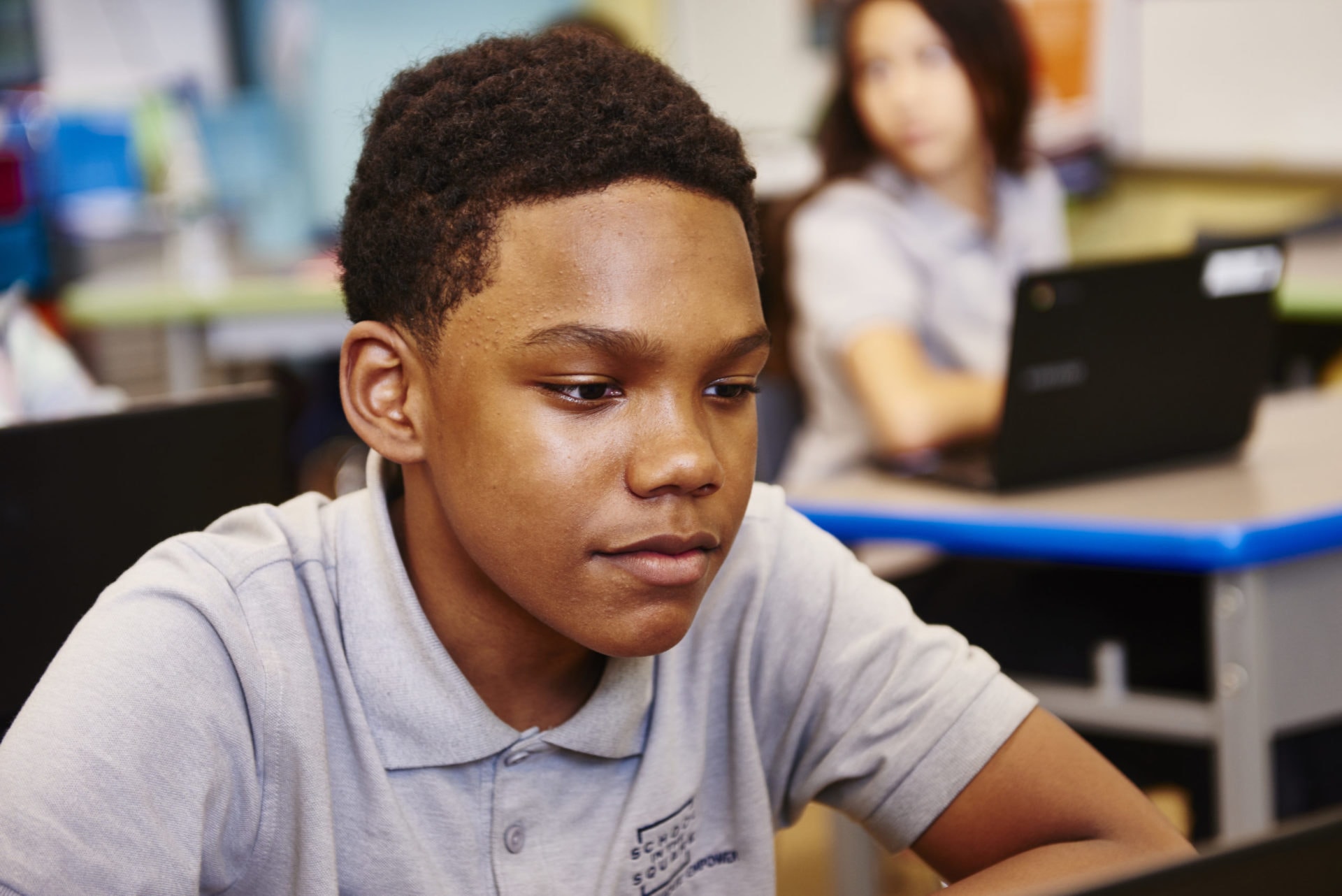 young man is sitting at laptop learning with tutor online