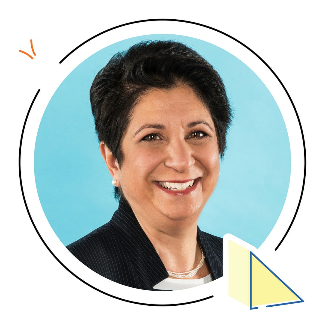 A smiling woman with short black hair, wearing a dark blazer and a white shirt, framed within a circular border on a light blue background, presents learning strategies from Sesame Workshop.
